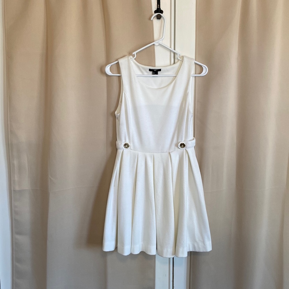 H&M cream colored tennis skirt/dress with gold button detail.